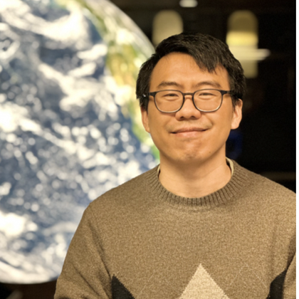 liang xue in front of an image of the earth
